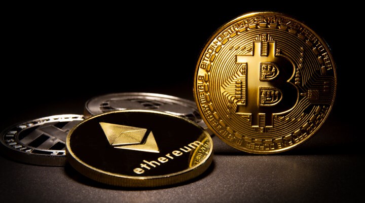 Bitcoin, Ethereum, Litecoin, and Ripple coins with soft portrait lighting